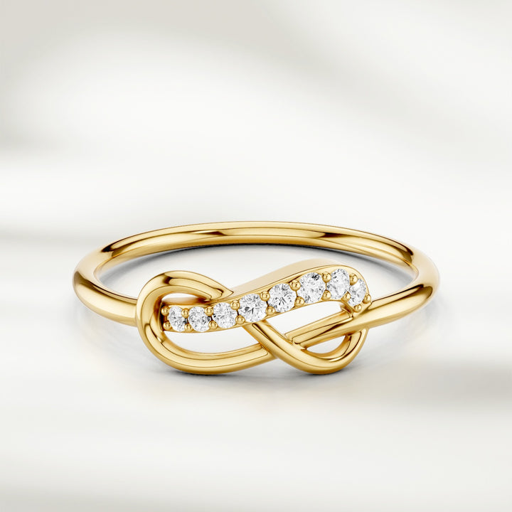 Infinity knot diamond ring in gold with slim polished band