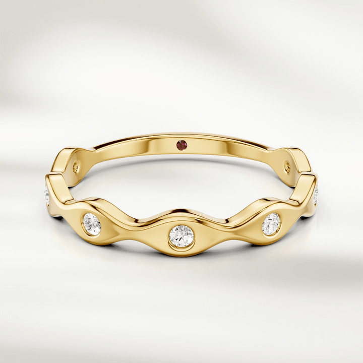 Wavy diamond band ring in 9kt yellow gold with bezel-set round diamonds