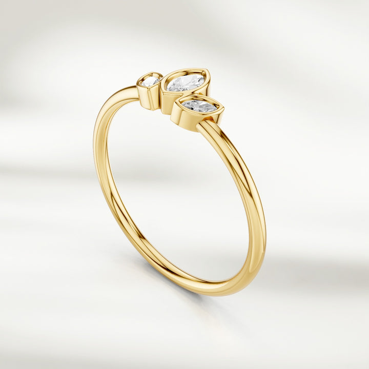 Angled view of gold marquise diamond cluster ring with three marquise diamonds in petal arrangement
