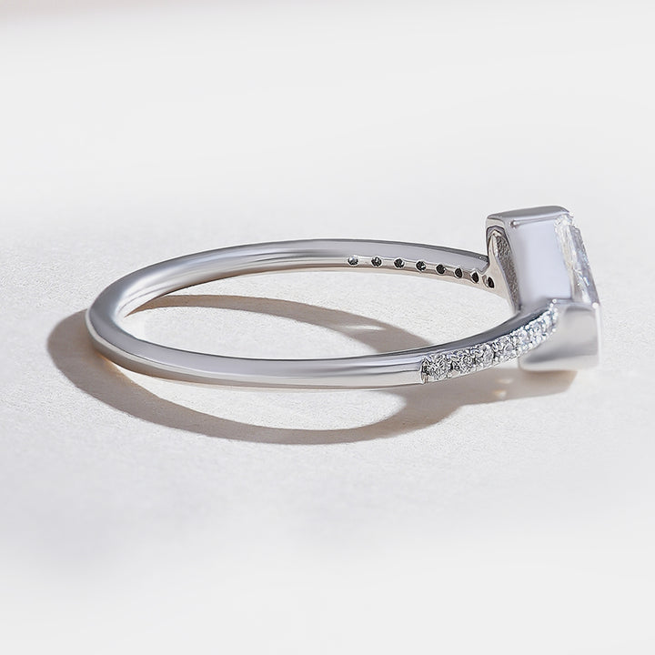 White gold shield-cut diamond solitaire ring with pavé-set band