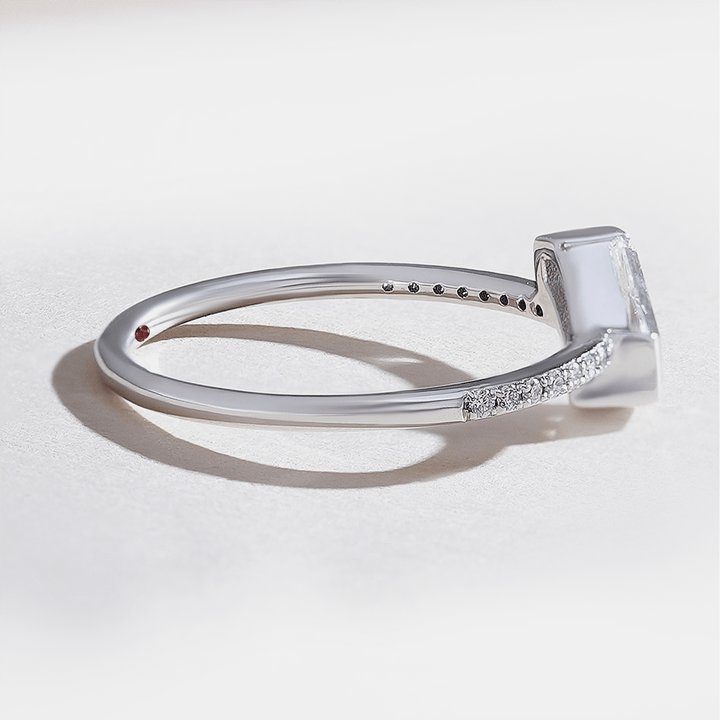 White gold shield-cut diamond solitaire ring with pavé-set band