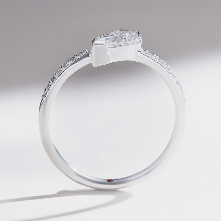 Side profile of 0.5 carat Aria shield solitaire ring in white gold with pavé-set band