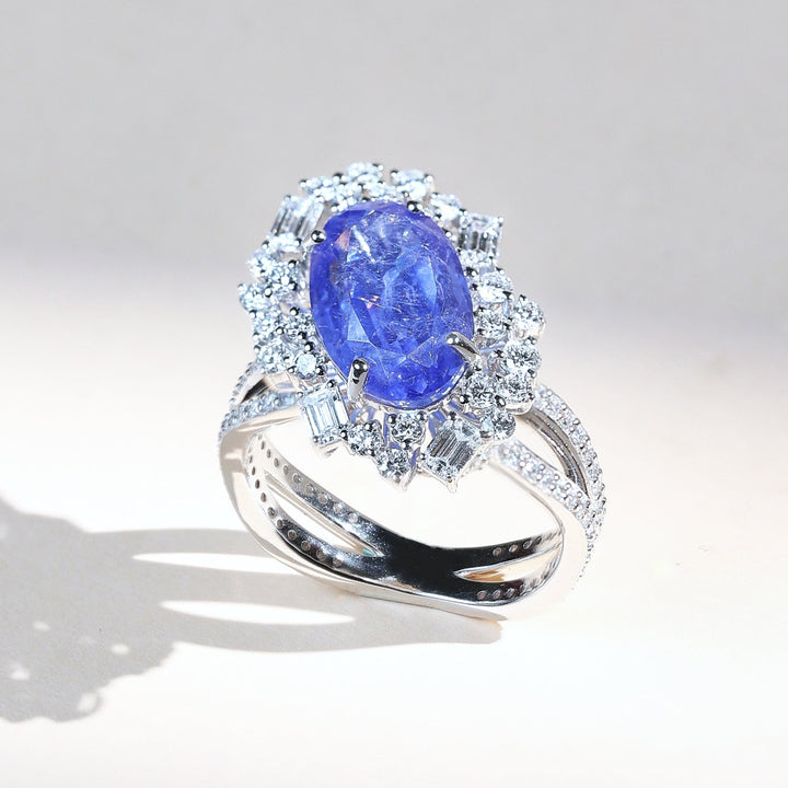 Azure Crest cocktail ring with oval blue sapphire surrounded by diamond halo in white gold