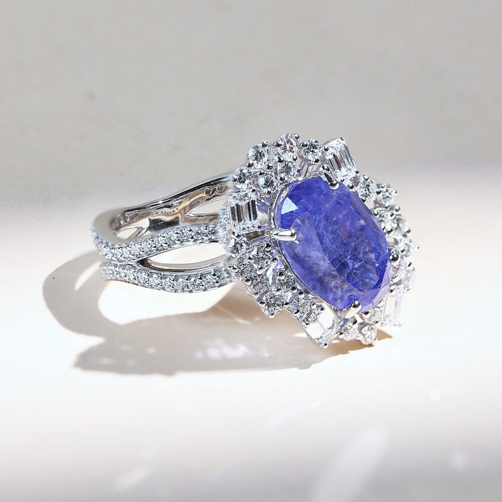 Angled view of Azure Crest ring featuring sapphire center and double diamond halo