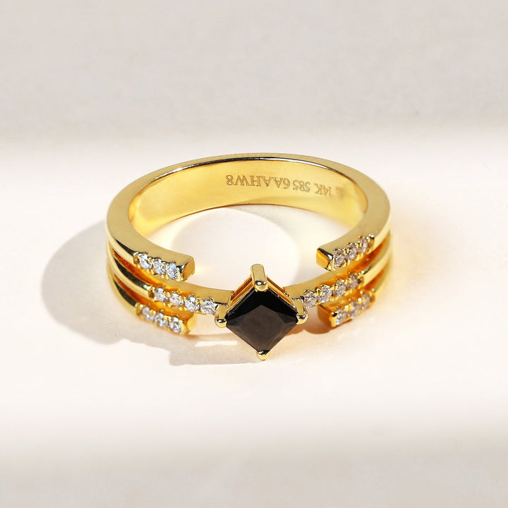 The Black Princess Fancy Ring with a square black diamond centerpiece set in yellow gold with dual diamond bands – front view