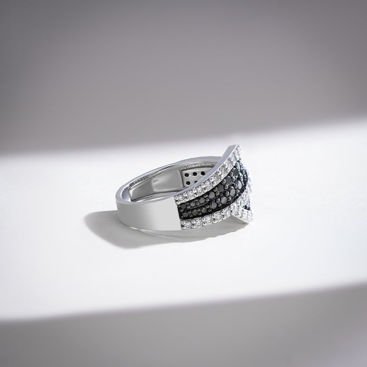Side profile of a white gold ring featuring black and white diamonds in an elegant curved setting.
