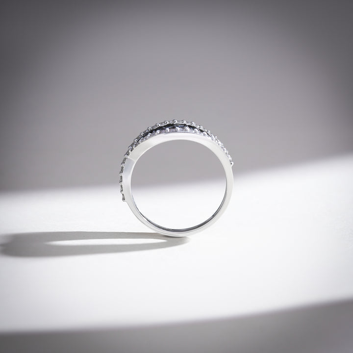 Slim white gold band with alternating black and white diamonds viewed from above for a clean silhouette.