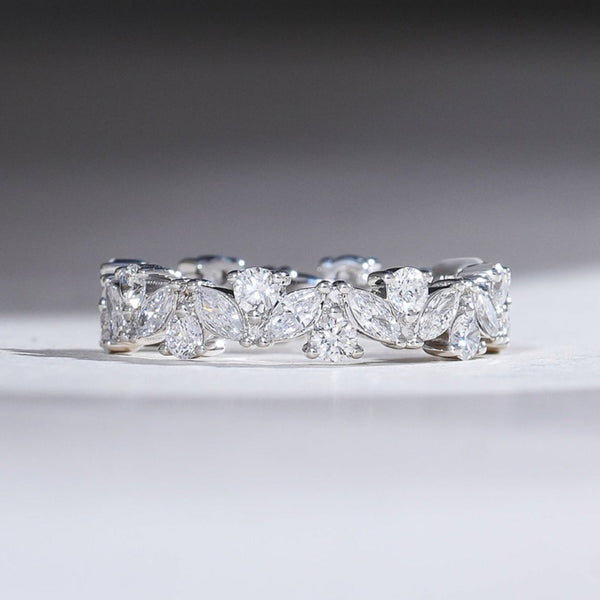 White gold eternity band with alternating marquise and round brilliant diamonds totaling 3 carats, creating a continuous sparkle.
