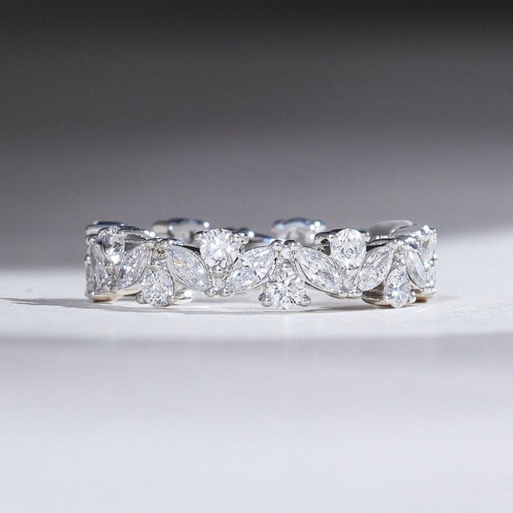 White gold eternity band with alternating marquise and round brilliant diamonds totaling 3 carats, creating a continuous sparkle.