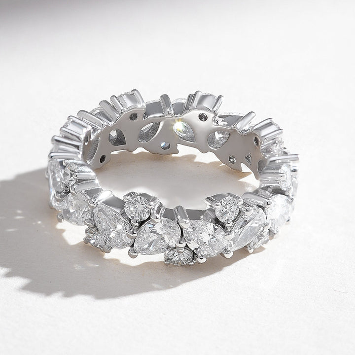 Angled view of the Celestial 3 Ct Pear & Round Eternity Band displaying its seamless eternity style.