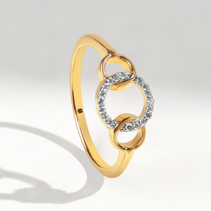 Gold ring with three interlinked circles, central circle set in diamonds, front view.