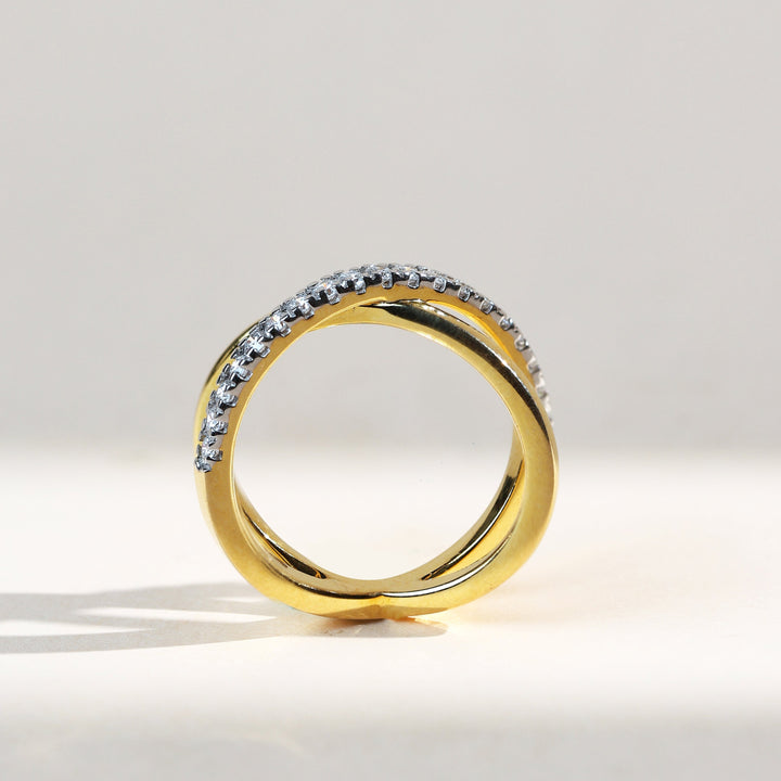 crossover-0.3-ct-dailywear-ring-profile-view.jpg – Profile view showing diamond-studded arc and plain gold crossover.