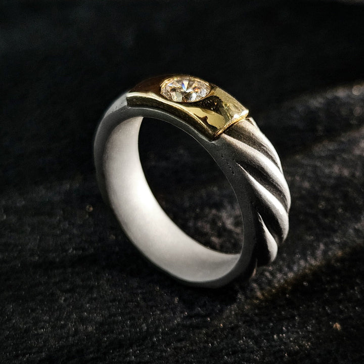 Front angled view of 0.5 Ct Czar Titanium Ring with twisted titanium band and bezel-set diamond in gold.