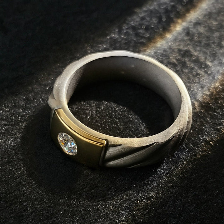 Top-down view of Czar Titanium Ring showing twisted titanium detail and flush diamond setting in gold.