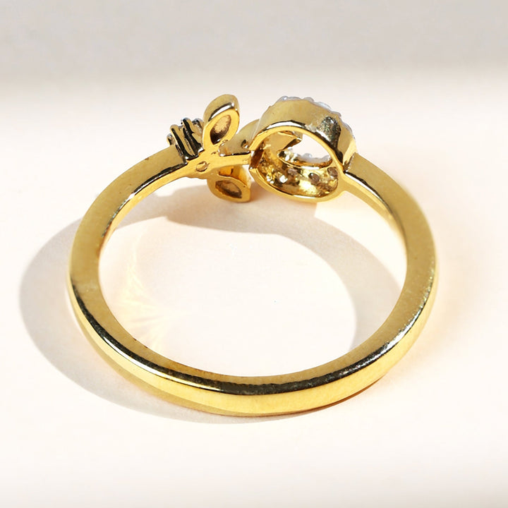 Back view of the Dandelion Dailywear Ring with polished gold band and detailed leaf setting