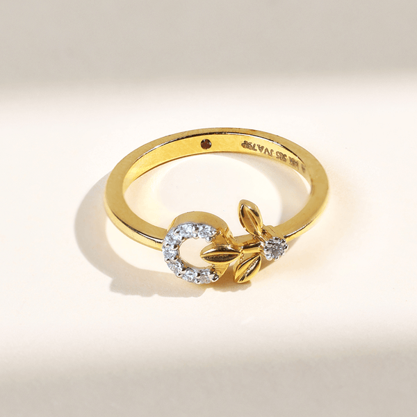 Close-up of Dandelion Dailywear Ring in yellow gold with a diamond-studded circular motif and leaf accents.