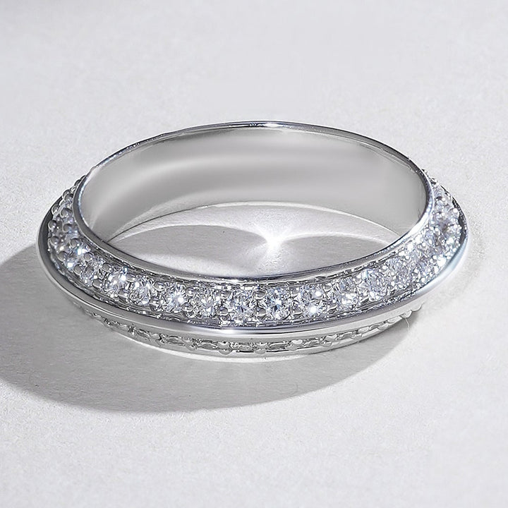 Angled view of white gold pavé diamond band with two glittering rows set in a rounded, polished frame.
