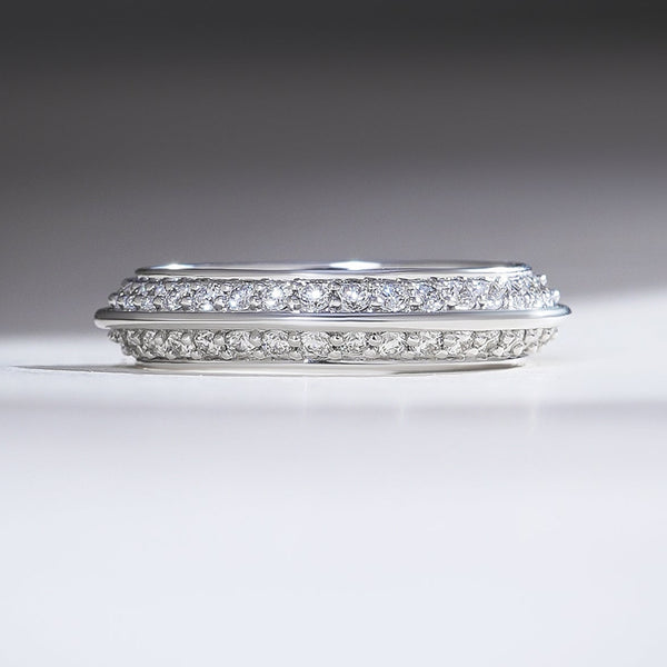 White gold band with double rows of pavé-set diamonds framed by a sleek polished edge for a modern finish.