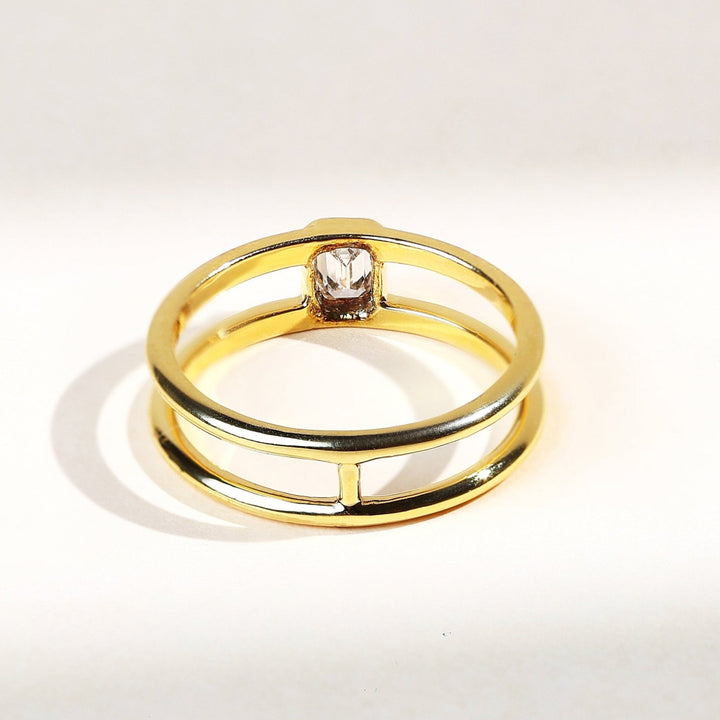 0.2 Ct Emerald Bezel Ring back view with sleek open dual band in yellow gold