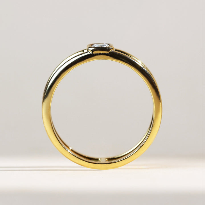 0.2 Ct Emerald Bezel Ring side profile highlighting bezel-set emerald-cut diamond