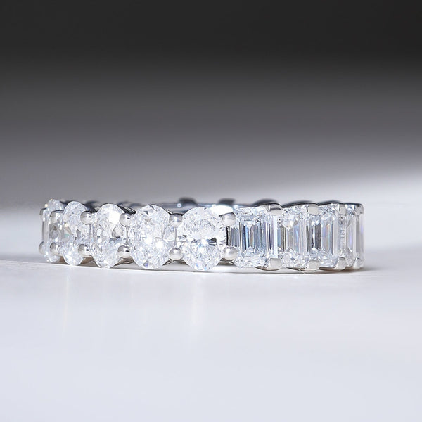 Front view of 4.8 Ct Emerald & Oval Eternity Band in white gold, featuring alternating emerald-cut and oval diamonds.
