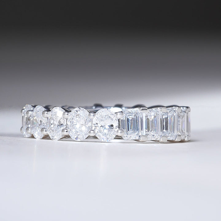 Front view of 4.8 Ct Emerald & Oval Eternity Band in white gold, featuring alternating emerald-cut and oval diamonds.
