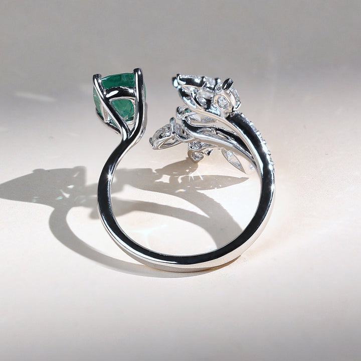 Side view of Emerald Vine cocktail ring featuring green emerald and pear-cut diamond leaves