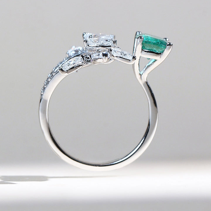 Profile view of Emerald Vine white gold ring with emerald and diamond leaves