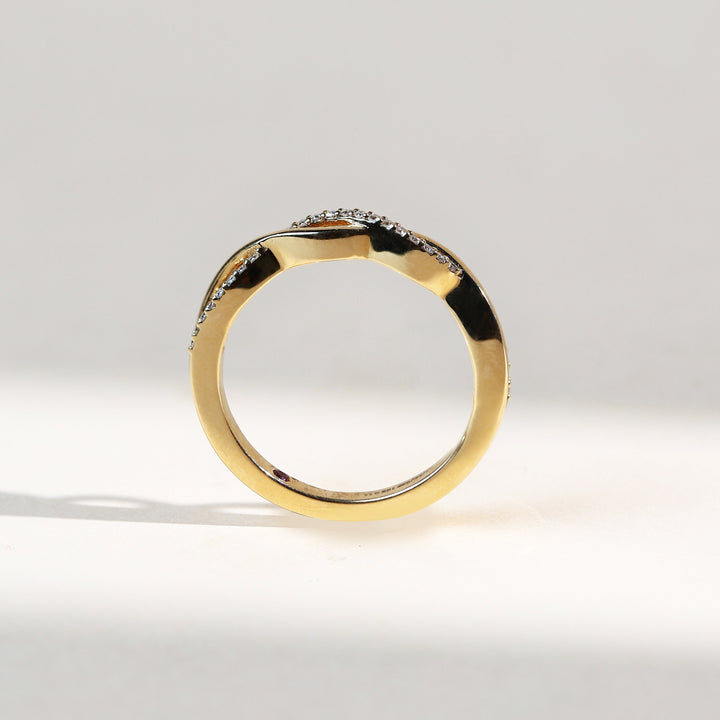 Profile shot of Entwined Promise Ring with diamond-set twisted front and plain gold underside