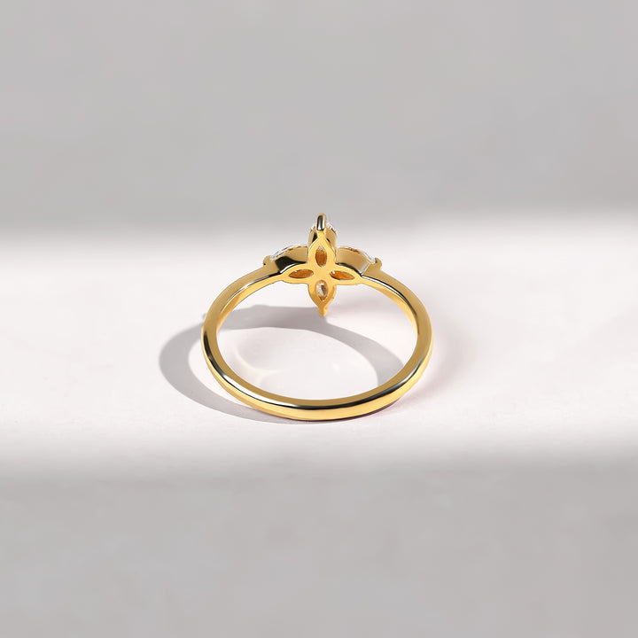 Back view highlighting the gold band with a cut-out floral pattern under the diamond petals