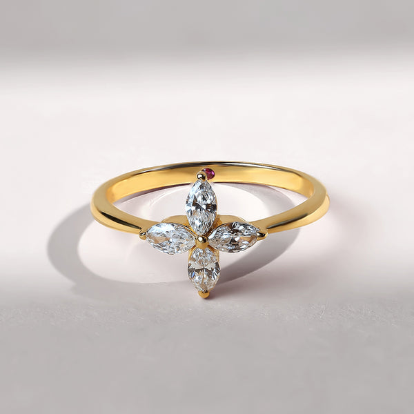 Front view of a gold ring with four marquise-cut diamonds forming a delicate flower shape.