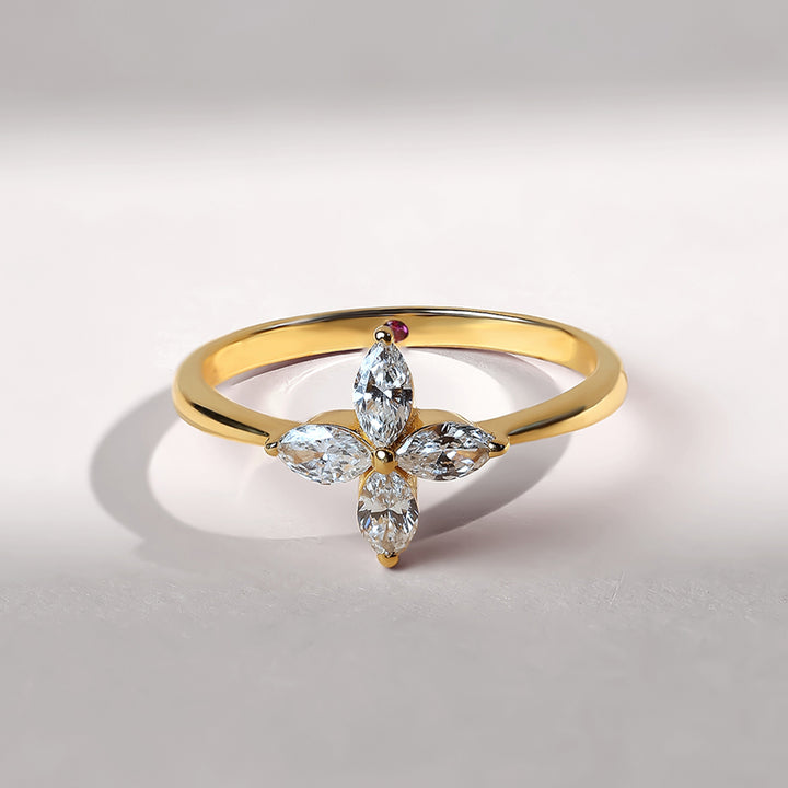 Front view of a gold ring with four marquise-cut diamonds forming a delicate flower shape.