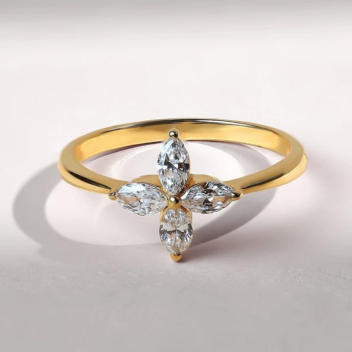 Front view of a gold ring with four marquise-cut diamonds forming a delicate flower shape.