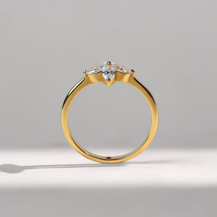 Profile view of the promise ring with slim gold band and floral diamond centerpiece.