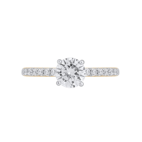Front view of Forever Ring featuring a 0.8 carat pear-shaped solitaire diamond with pavé band in yellow gold.