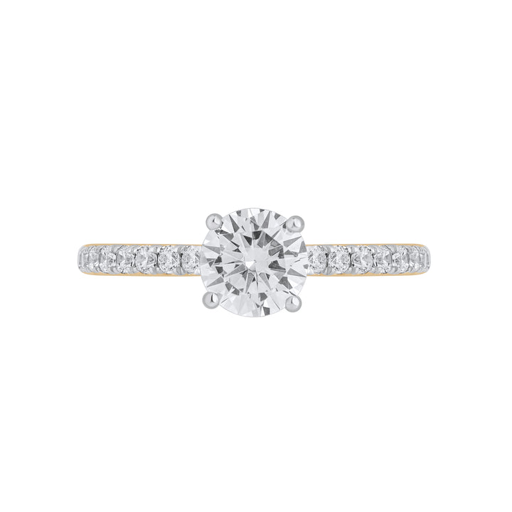 Front view of Forever Ring featuring a 0.8 carat pear-shaped solitaire diamond with pavé band in yellow gold.