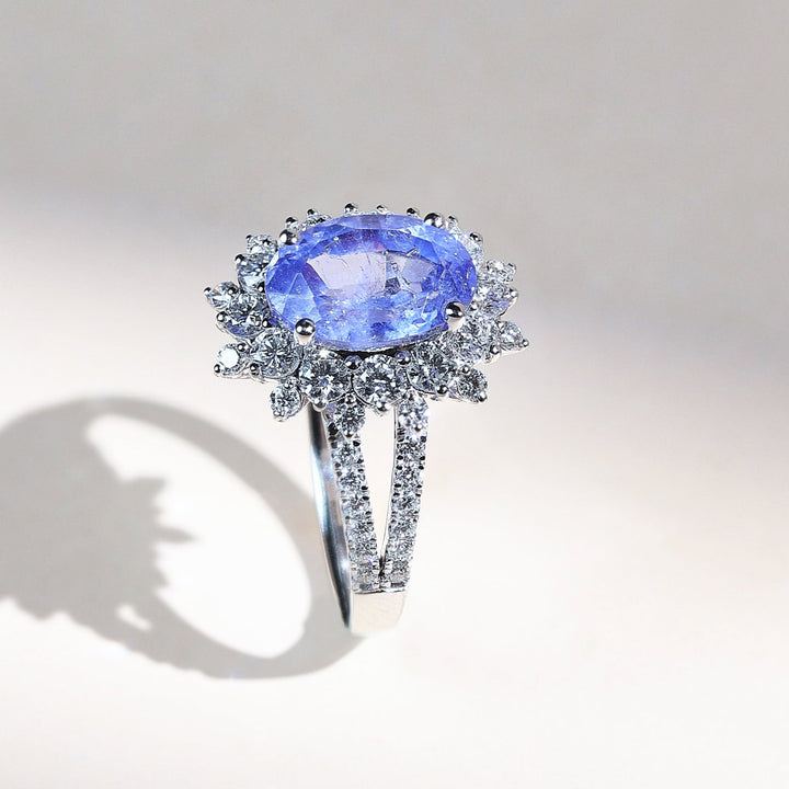 Side view of French Riviera Iconic Cocktail Ring with oval blue gemstone and diamond accents
