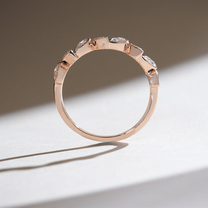 Profile view highlighting the setting of marquise and pear-shaped diamonds in rose gold