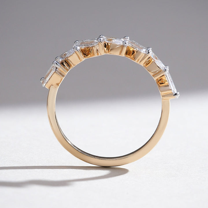 Profile view of yellow gold half-eternity band with alternating marquise and baguette diamonds.