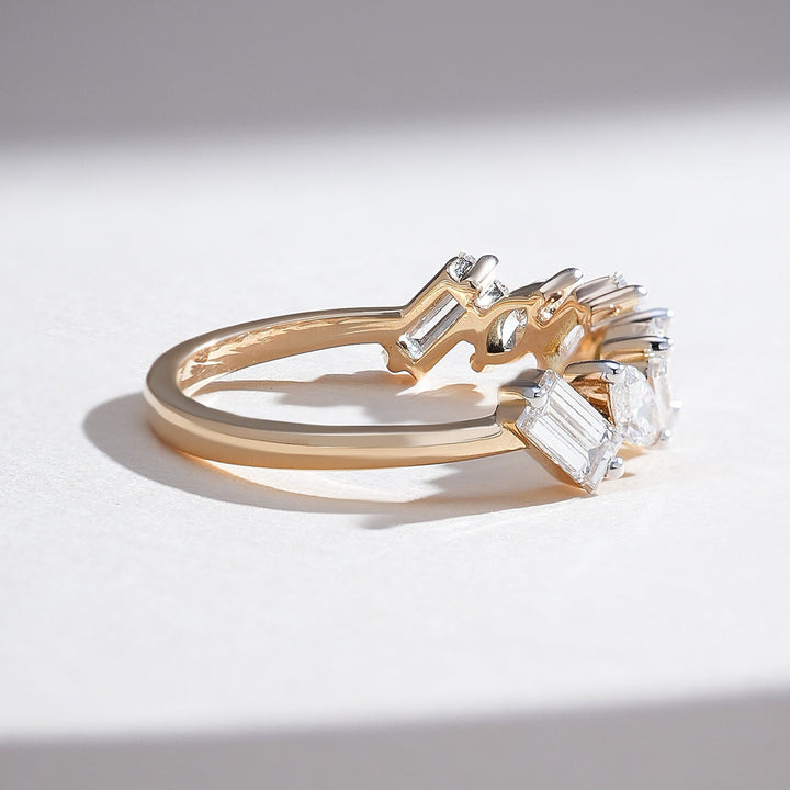 Side view of yellow gold half-eternity band showcasing angled marquise and baguette diamond arrangement