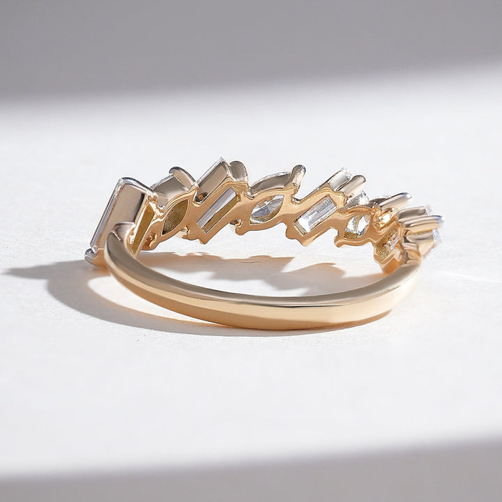 Top angle of marquise and baguette diamond half-eternity ring, highlighting open gold setting
