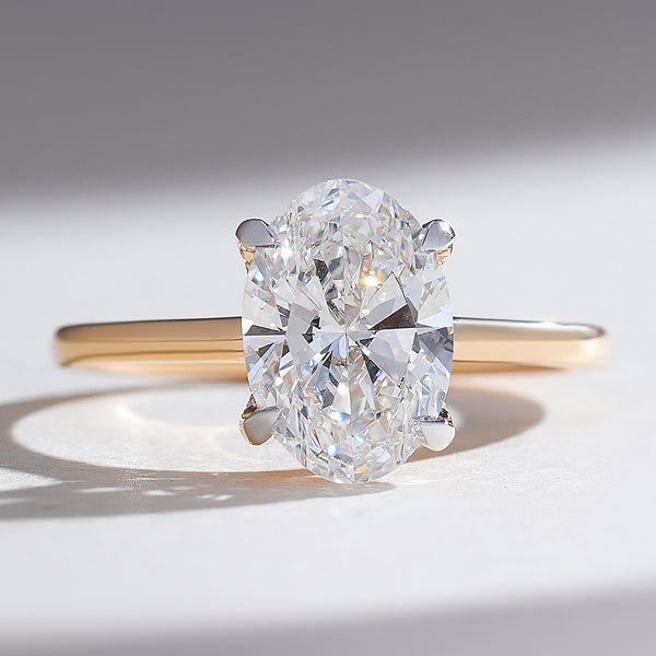 Close-up front view of the Hidden Harmony 2 Ct Oval Solitaire Ring in yellow gold with a hidden halo.
