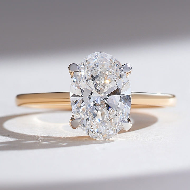 Close-up front view of the Hidden Harmony 2 Ct Oval Solitaire Ring in yellow gold with a hidden halo.