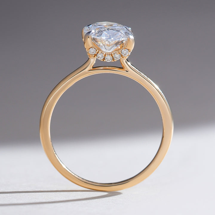 Profile view of the Hidden Harmony 2 Ct Oval Solitaire Ring, displaying the slender band and hidden halo accents.