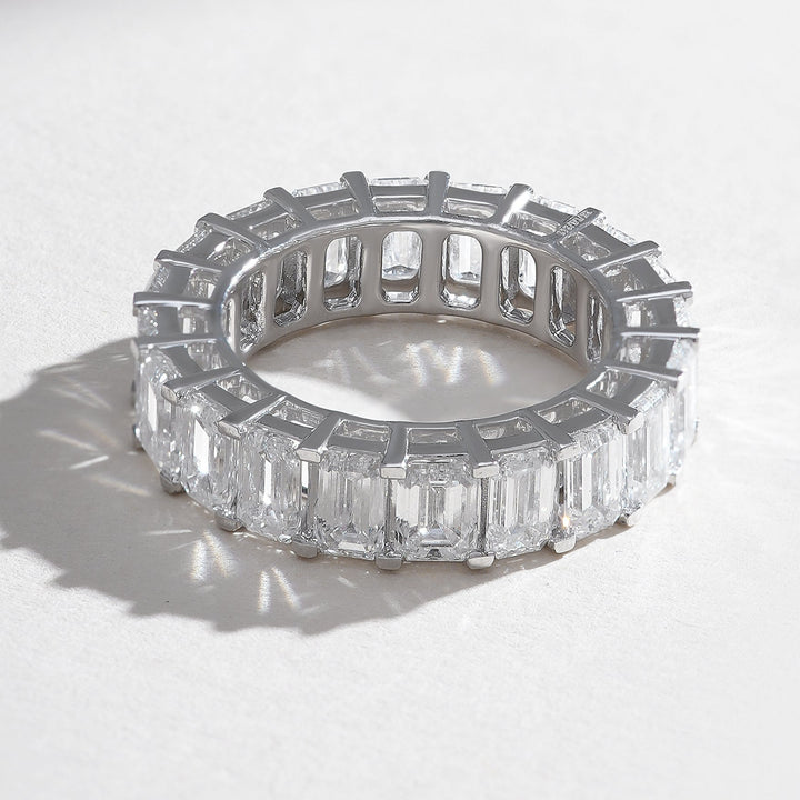 Angled view highlighting the brilliance and symmetry of emerald-cut diamonds in the eternity band.