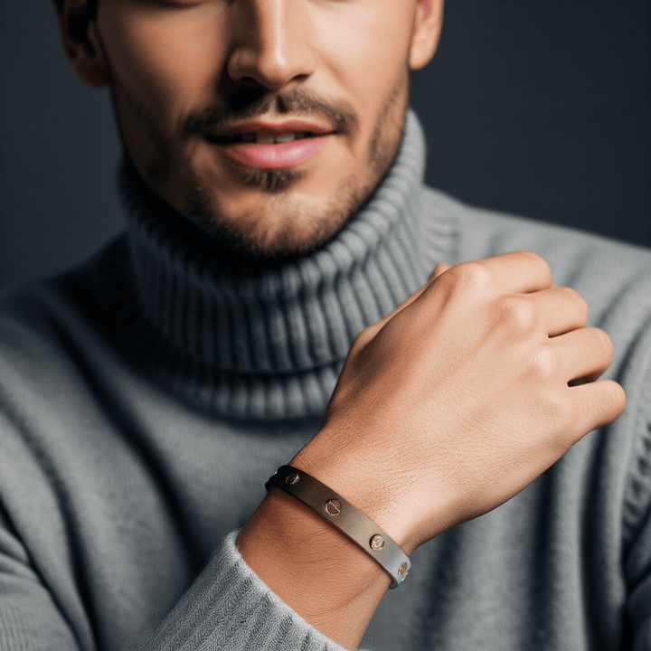 0.3 Ct Imperium Titanium Bracelet worn by a man in a grey turtleneck, matte titanium cuff with bezel-set diamonds in gold.