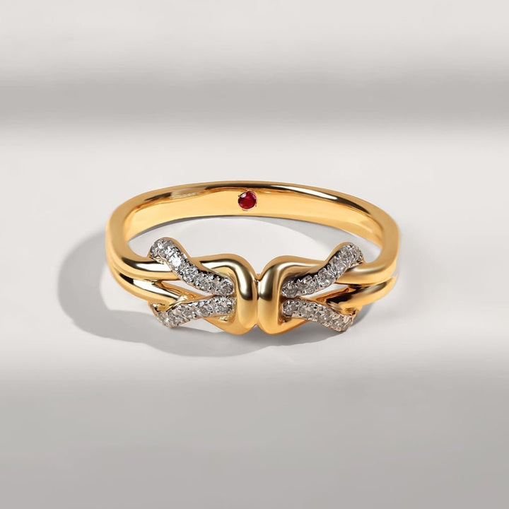 Angled view of Invisible Bond Promise Ring showing twin bands merging into a diamond knot.