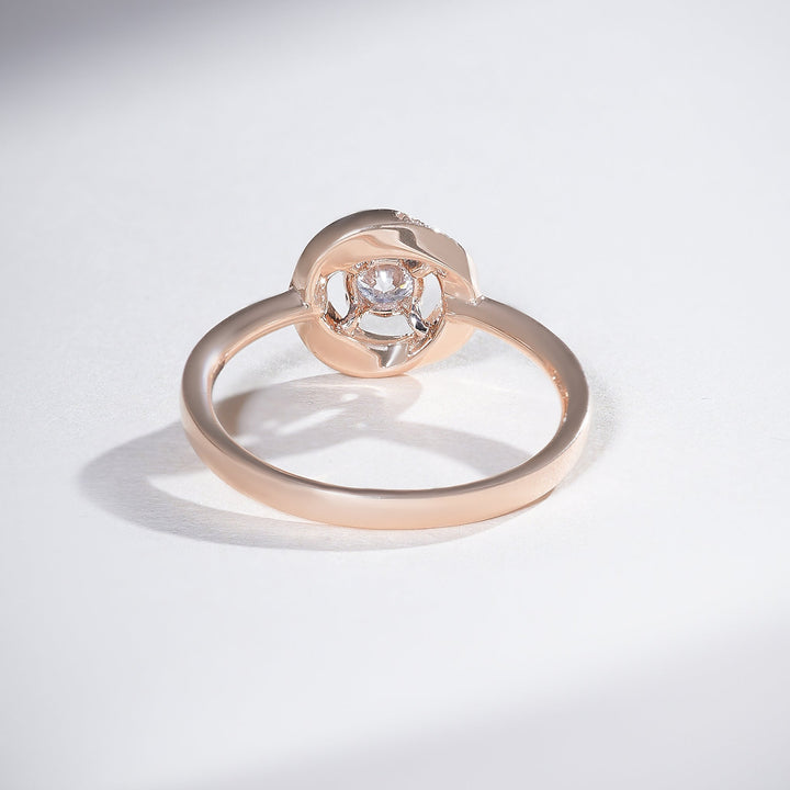 Rose-gold halo solitaire ring revealing the open gallery and circular halo underside.