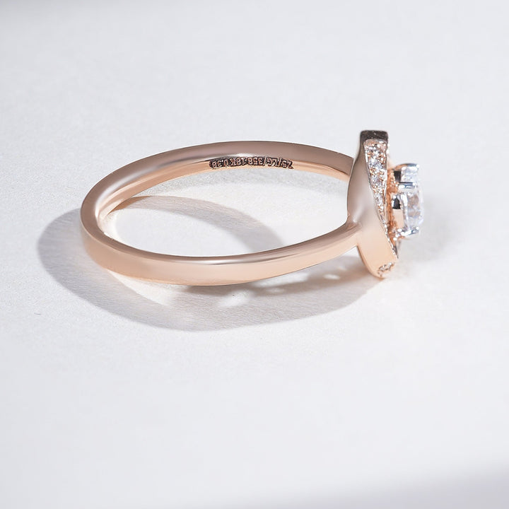 0.3-ct round halo solitaire in rose gold, showing pavé shoulder and a low basket setting.