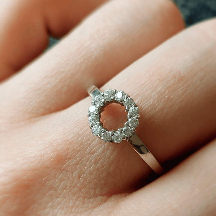 Lifestyle shot of 0.1 Ct Little Halo Ring worn on hand, showcasing diamond halo.